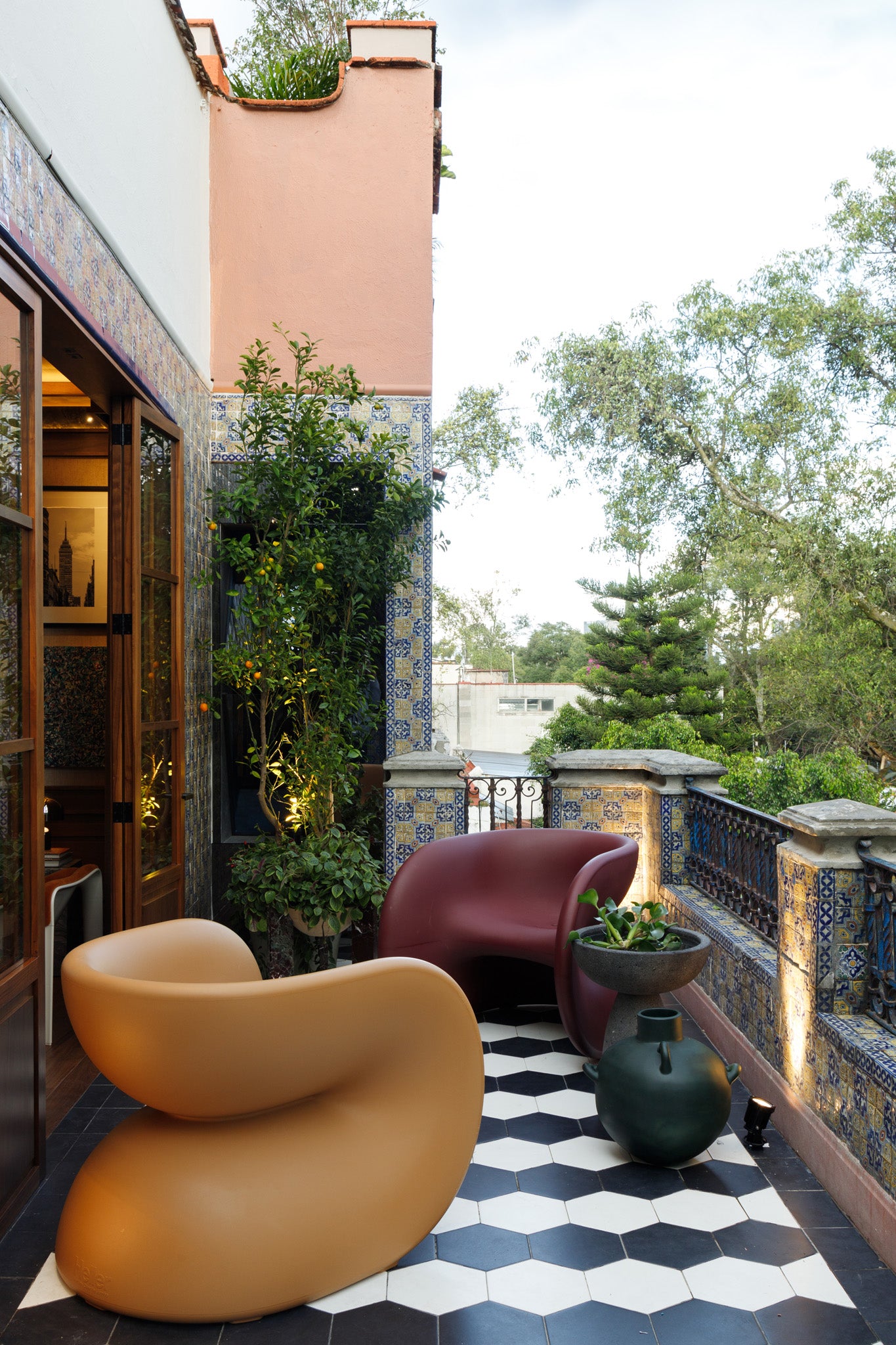 Fortune Chair by Heller Furniture in Cookie and Dark Cherry on a kush modern balcony in Mexico
